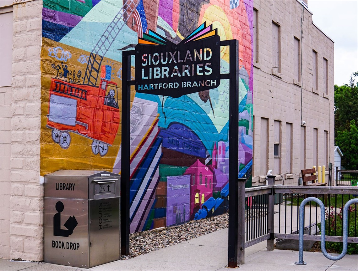 Hartford exterior sign, book drop, and mural