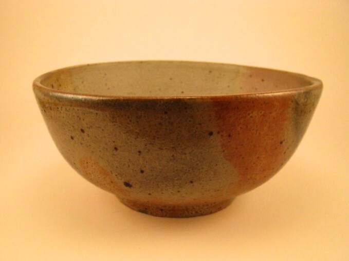 Cone 10 reduction grey stoneware bowl with coral flashing.