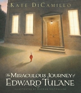The Miraculous Journey of Edward Tulane book cover art featuring a small anthropomorphic rabbit dressed in a red suit approaching the entrance of a stone building with marble columns on either side of the door.