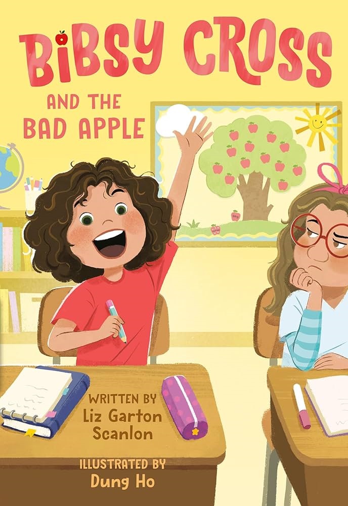 Book cover for Bibsy Cross and the Bad Apple by Liz Garton Scanlon. A female student wearing a red t shirt is seated at a classroom desk raising her hand. Another female student is seated next to her, looking at the other student unimpressed.