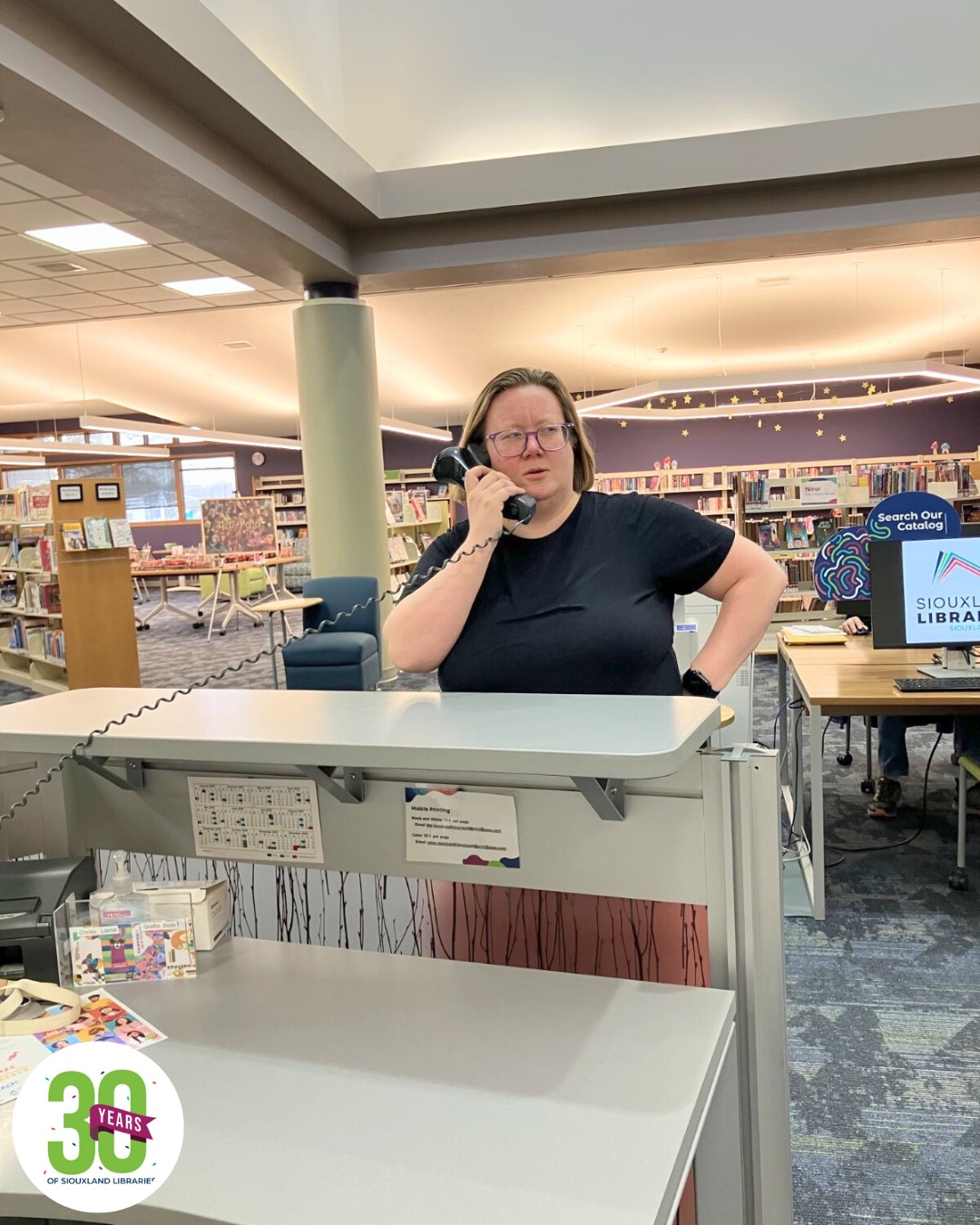 Present-day staff member on the phone