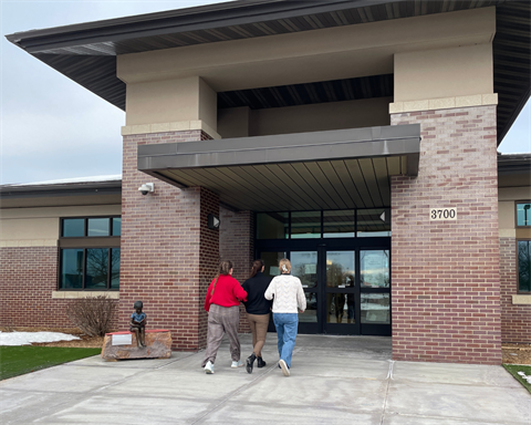 Arm-in-arm Oak View staff walk in the front doors.