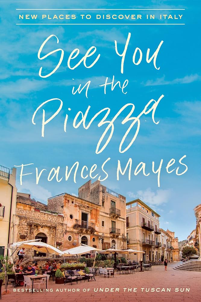 Book Cover: See You in the Piazza by Frances Mayes A line of Italian buildings bordering a piazza with outdoor shaded seating. People gather and sit together on a sunny day.